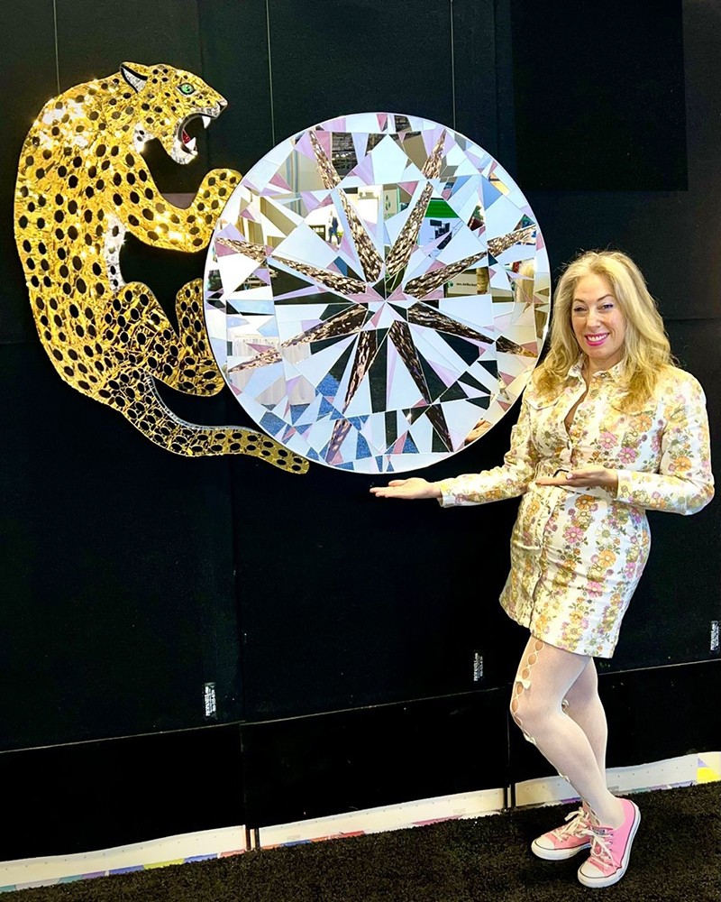 Allison Eden with a sculptural leopard and oversized pink diamond artwork handcrafted from glass and mirror