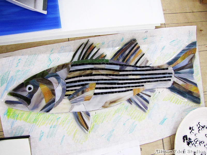 Striped bass glass mosaic artwork in progress showing hand-cut pieces