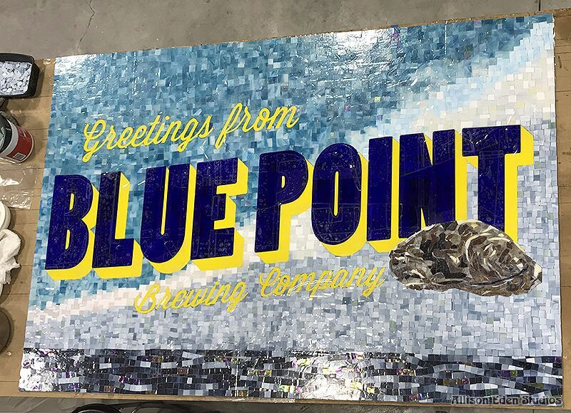Large handcrafted stained glass mosaic "Greetings from Blue Point Brewing Company" welcome sign featuring an oyster and ocean-inspired colors by Allison Eden Studios