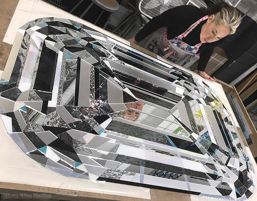 Allison Eden handcrafting a large diamond-inspired mirror mosaic artwork in her Brooklyn studio for the Eau Spa Palm Beach luxury hospitality installation.