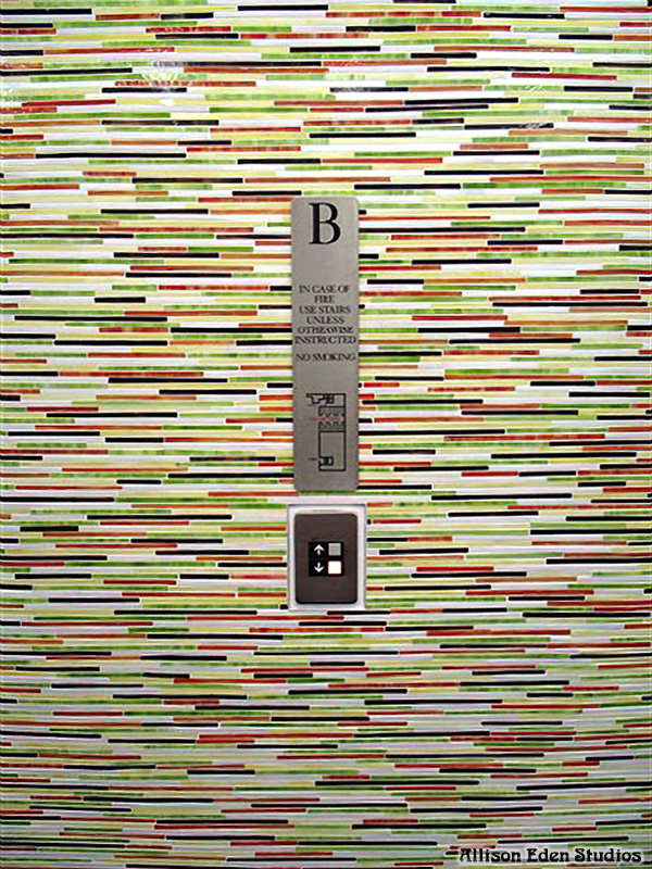 Commercial stained glass mosaic tile installation surrounding elevator doors at L'Oréal Paris headquarters designed by Allison Eden Studios.