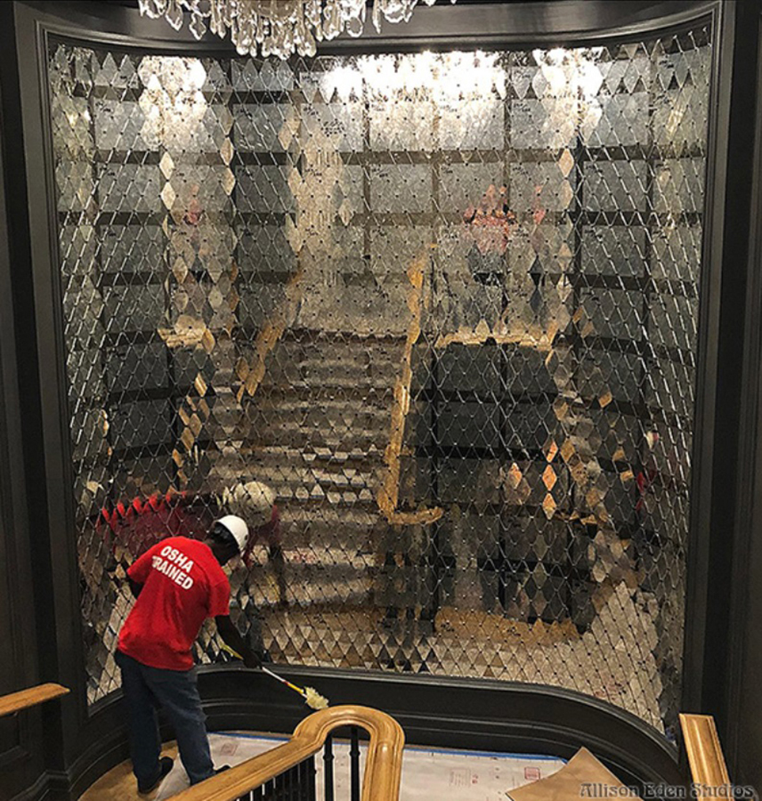 Custom antique mirror diamond mosaic feature wall designed by Allison Eden Studios for a luxury Palm Beach hotel staircase, reflecting light and creating a shimmering architectural focal point.