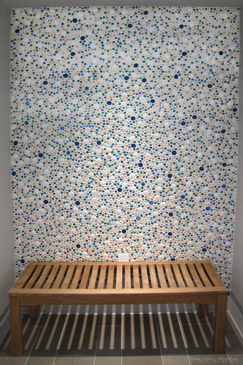Custom handcrafted glass bubble mosaic wall by Allison Eden Studios featuring thousands of circular stained glass pieces in blue, aqua, white, and sand tones for a luxury beach club changing room and wellness spa.