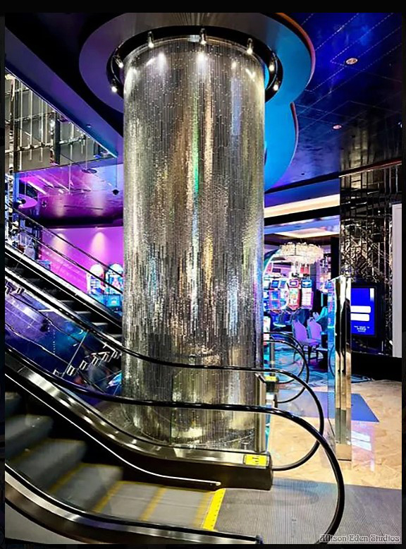Custom handcrafted mirror mosaic columns by Allison Eden Studios at the Vesper Bar inside The Cosmopolitan Las Vegas featuring a three-tone linear mirror design for columns by escalators.
