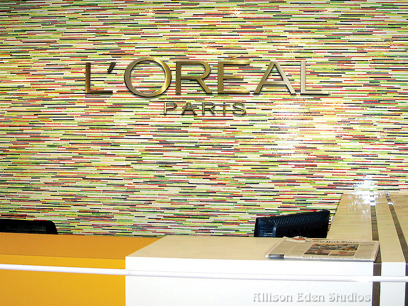 Custom colorful stained glass mosaic tile wall surrounding the elevator controls at L'Oréal Paris New York headquarters by Allison Eden Studios.