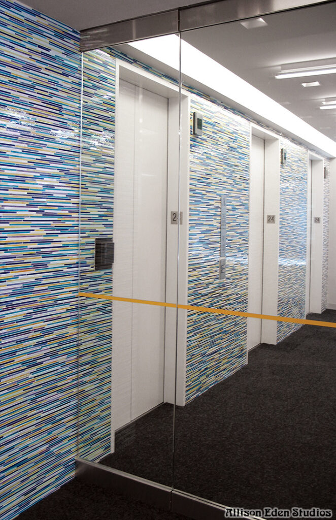 Blue custom stained glass mosaic tile elevator lobby at L'Oréal Paris headquarters handcrafted by Allison Eden Studios.