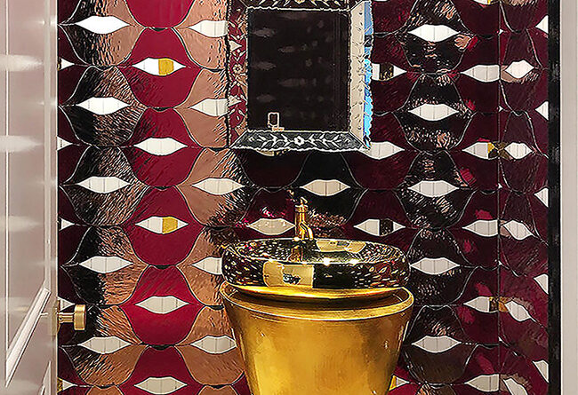 Gold pedestal sink surrounded by custom red SMILE Lips stained glass and mirror mosaic in a luxury powder room.gold sink small