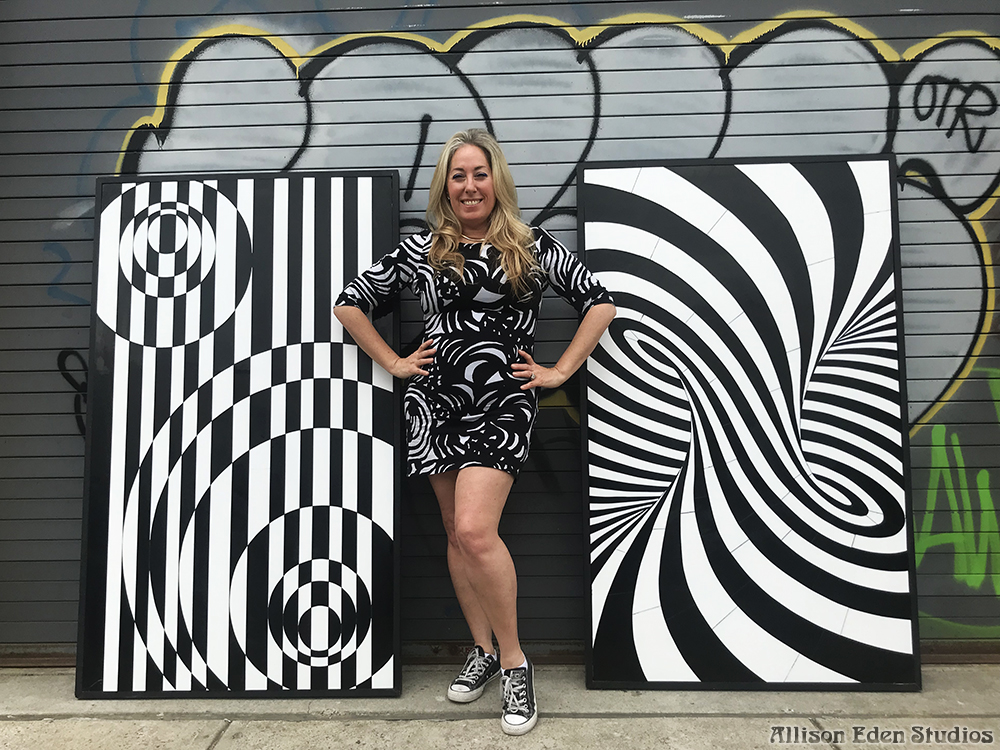 Allison Eden with two black and white optical illusion glass mosaic artworks handcrafted in Brooklyn