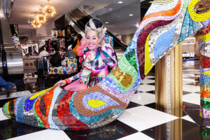 Mosaic High Heeled Shoe Sculpture at Bloomingdales Allison Eden pop up shop with Allison Eden sitting inside giant shoe.