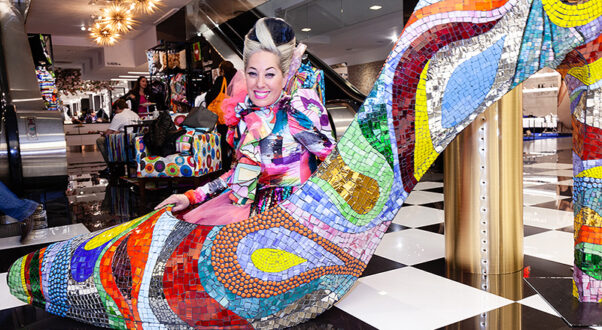 Mosaic High Heeled Shoe Sculpture at Bloomingdales Allison Eden pop up shop with Allison Eden sitting inside giant shoe.