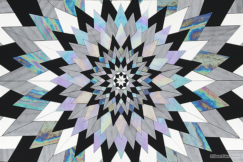 Custom stained glass mosaic artwork by Allison Eden Studios featuring a geometric black, white, silver and iridescent kaleidoscope starburst.