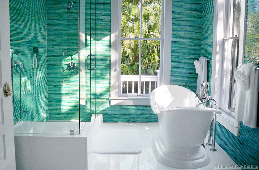 Custom green and turquoise glass mosaic bathroom with freestanding white bathtub by Allison Eden Studios