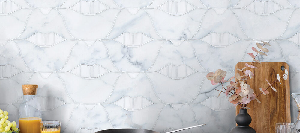 White marble kitchen backsplash featuring Allison Eden Studios SMILE Lips stone mosaic in Calacatta Gold, Thassos and Bianco Dolomite.