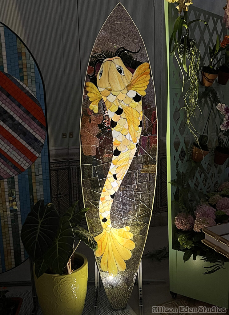 Mosaic Koi Fish Surfboard at Colony Hotel for Holiday House event designed by Allison Eden Studios- imageat night,