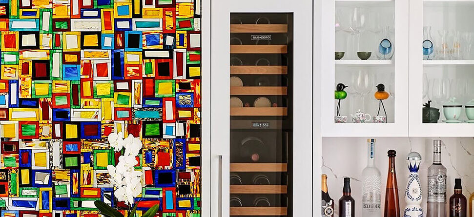 Handcrafted Tiki Blocks™ stained glass mosaic feature wall by Allison Eden Studios surrounding a custom wine room, adding bold color and artistic impact to a luxury modern home.