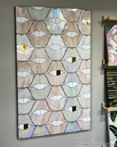SMILE Lips stained glass and mirror mosaic artwork by Allison Eden Studios featuring blush glass, iridescent white glass, and a signature gold tooth for luxury contemporary art collectors.