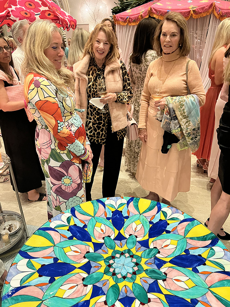 Allison Eden with stained glass mosaic Kaleidoscope coffee Table at The Colony Palm Beach with art admirers.