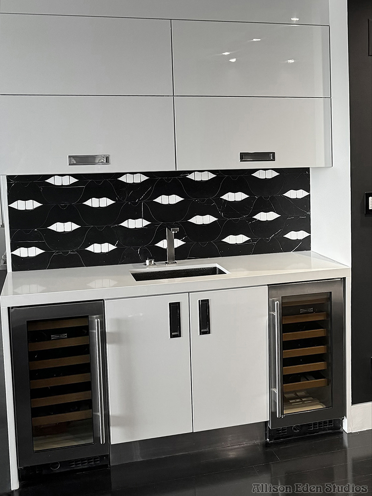 Black and white SMILE Lips stone mosaic backsplash with white cabinetry in a modern home bar by Allison Eden Studios.