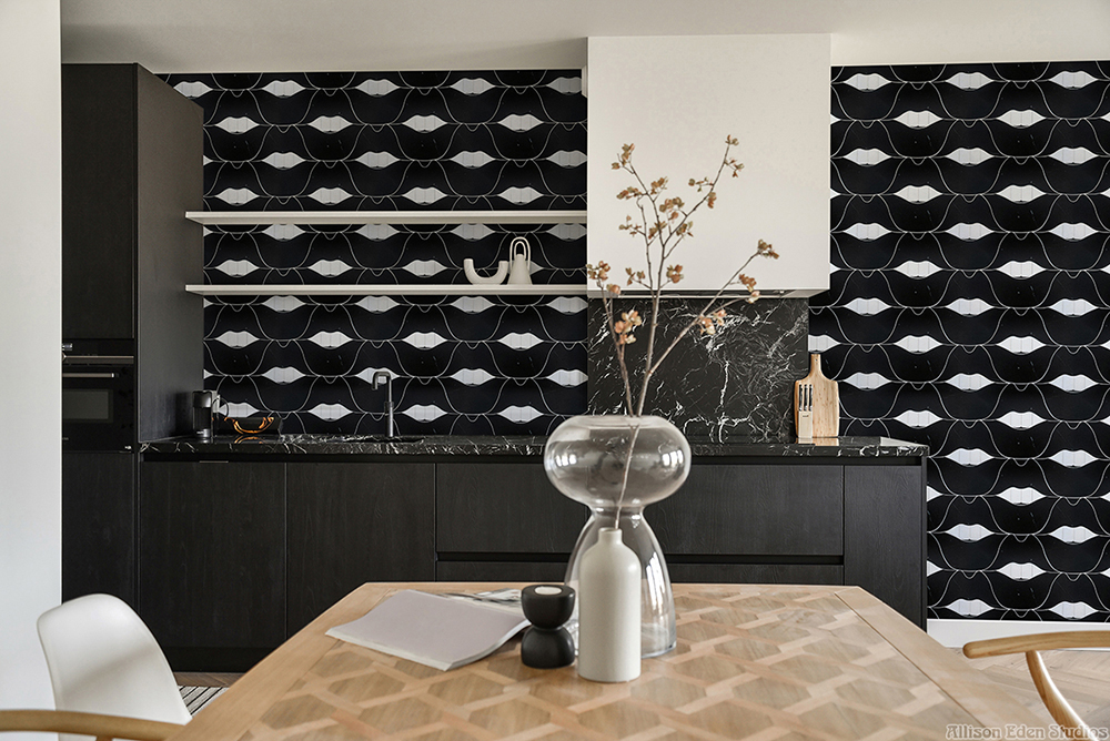 Black and white SMILE Lips stone mosaic feature wall in a contemporary luxury bathroom.
