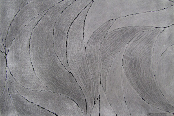 Custom Fire & Wind luxury area rug by Allison Eden Studios in a contemporary living room with flowing green, cream, gray and charcoal waves.