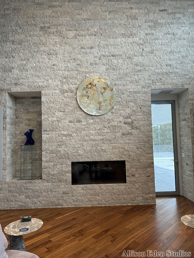 48-inch handcrafted glass mosaic moon artwork by Allison Eden displayed at Villa Luna in the Hamptons during daylight.