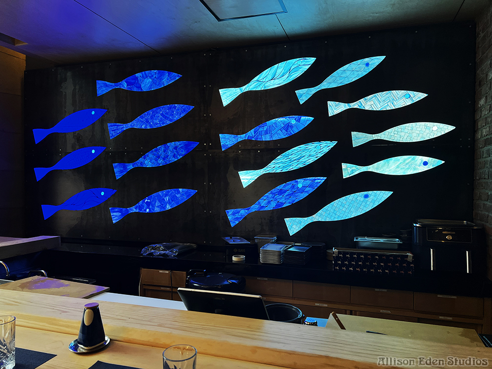 Custom backlit stained glass mosaic fish installation by Allison Eden Studios at Bondi Sushi in Bryant Park NYC.