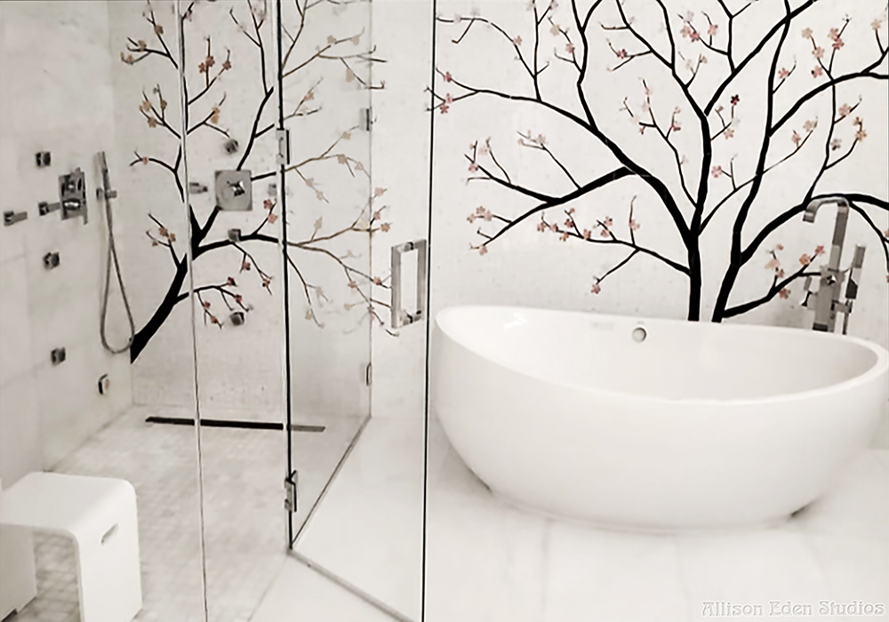 Luxury white bathroom with custom cherry blossom glass mosaic extending across the shower and bathtub wall