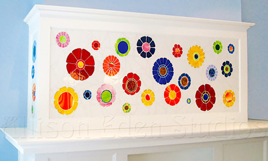 Colorful handmade floral stained glass mosaic inset into a traditional mantel