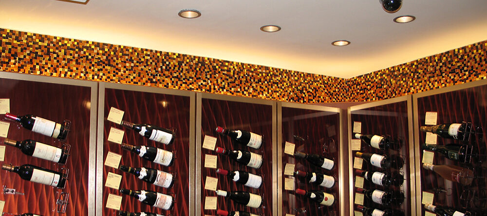 Custom amber, chocolate and gold stained glass mosaic border by Allison Eden Studios inside the Astor Liquors wine room in Greenwich Village NYC.