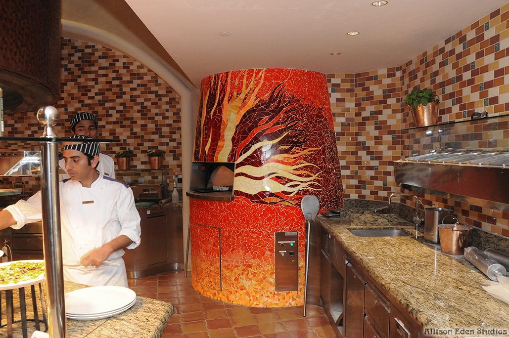 Fire-inspired stained glass mosaic pizza oven at Atlantis Dubai with red, orange and gold glass handcrafted by Allison Eden Studios.