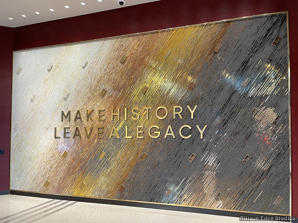Monumental glass mosaic feature wall at Circa Resort & Casino in Las Vegas, with a diagonal ivory-to-chocolate ombré pattern and gold Make History Leave a Legacy lettering.