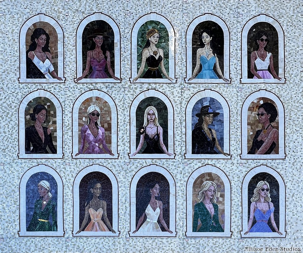 Girls in Windows by Allison Eden, a large-scale stained glass mosaic artwork featuring 15 individually handcrafted women framed in architectural windows.
