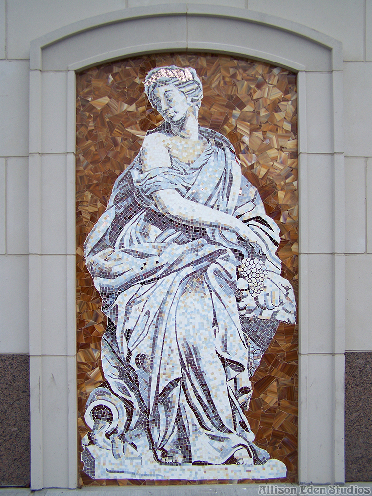 Handcrafted Greek goddess glass mosaic mural by Allison Eden featuring a classical draped female figure in white and silver glass against a bronze background at Vitro, Staten Island.