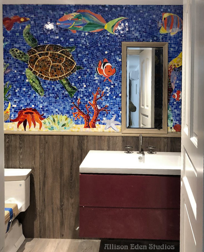 Handcrafted marine life mosaic bathroom by Allison Eden Studios with tropical fish, sea grasses, coral and sea turtle in vivid blue stained glass.